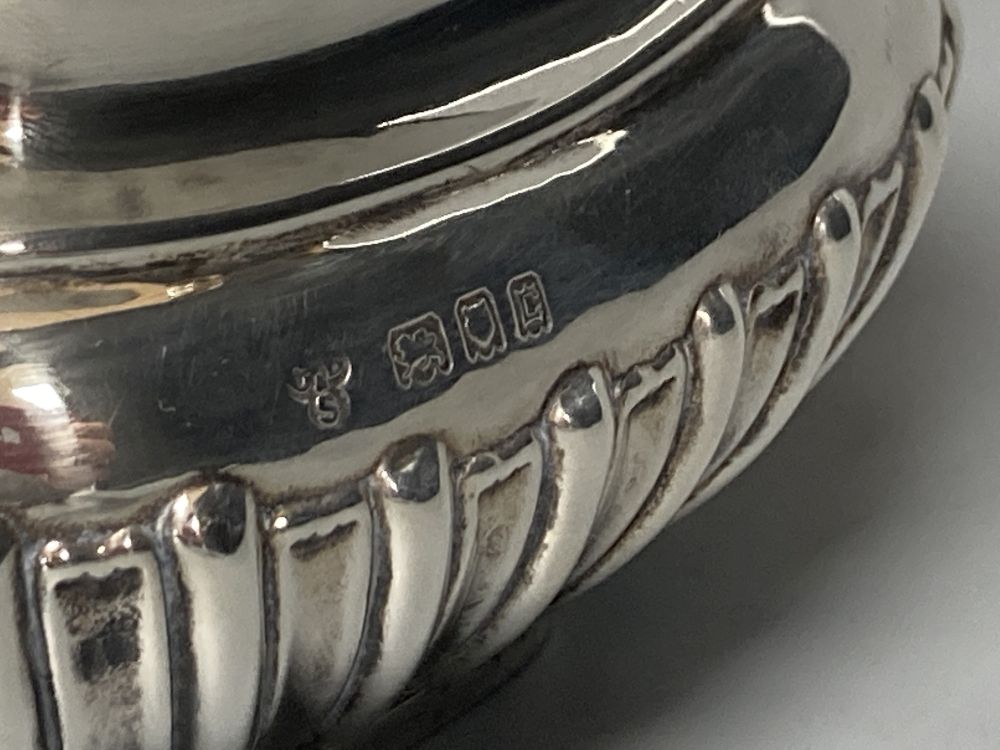 A George V demi fluted silver four piece tea set by Charles Boyton & Son Ltd, London 1918 and 1922,
